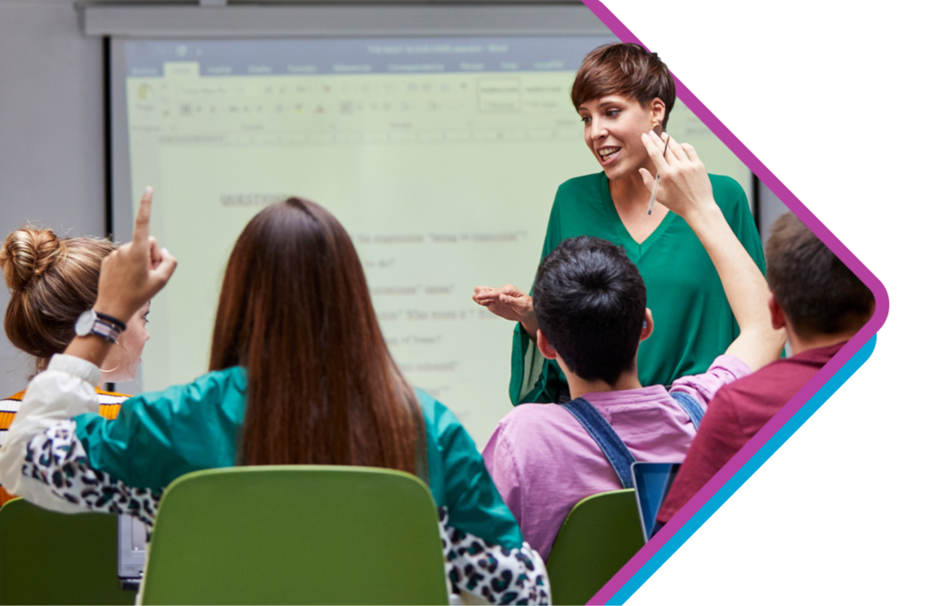 Teacher in classroom with high-school-aged students